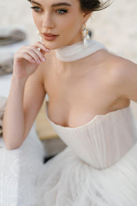 Introducing the Bridget Corset Gown, a modern twist on the timeless ballgown silhouette. With its soft net tie and Georgian-style corsetry, this gown exudes romance and structure. Delicate tucks add an element of intrigue, creating a unique and elegant creation that embodies contemporary style. Crafted from soft netting, the Bridget Corset Gown is a perfect blend of modern and classic design.