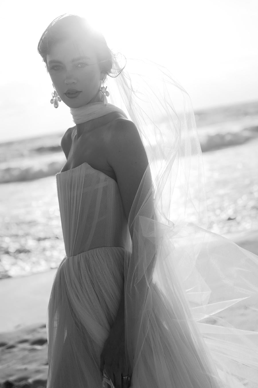 Introducing the Bridget Corset Gown, a modern twist on the timeless ballgown silhouette. With its soft net tie and Georgian-style corsetry, this gown exudes romance and structure. Delicate tucks add an element of intrigue, creating a unique and elegant creation that embodies contemporary style. Crafted from soft netting, the Bridget Corset Gown is a perfect blend of modern and classic design.