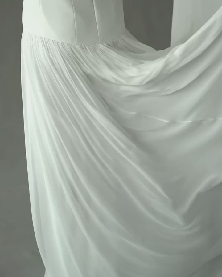 Experience luxury with the Clara Crepe Gown. Made from 100% satin silk crepe, this strapless gown offers a comfortable and elegant fit. The drop waist adds a touch of sophistication, making it the perfect choice for any special occasion. Available in a beautiful off-white color.