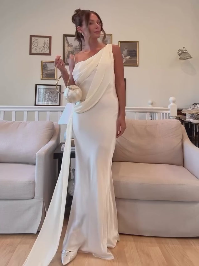 The Helena Dress embodies understated elegance with its signature one-shoulder silhouette. Crafted from luxurious charmeuse that flows gracefully against the body, this pull-on style eliminates the need for closures while delivering effortless sophistication. The fully lined interior ensures comfort and confidence through any occasion. Proudly made in Australia with meticulous attention to detail, it transitions seamlessly from special events to refined everyday moments. 