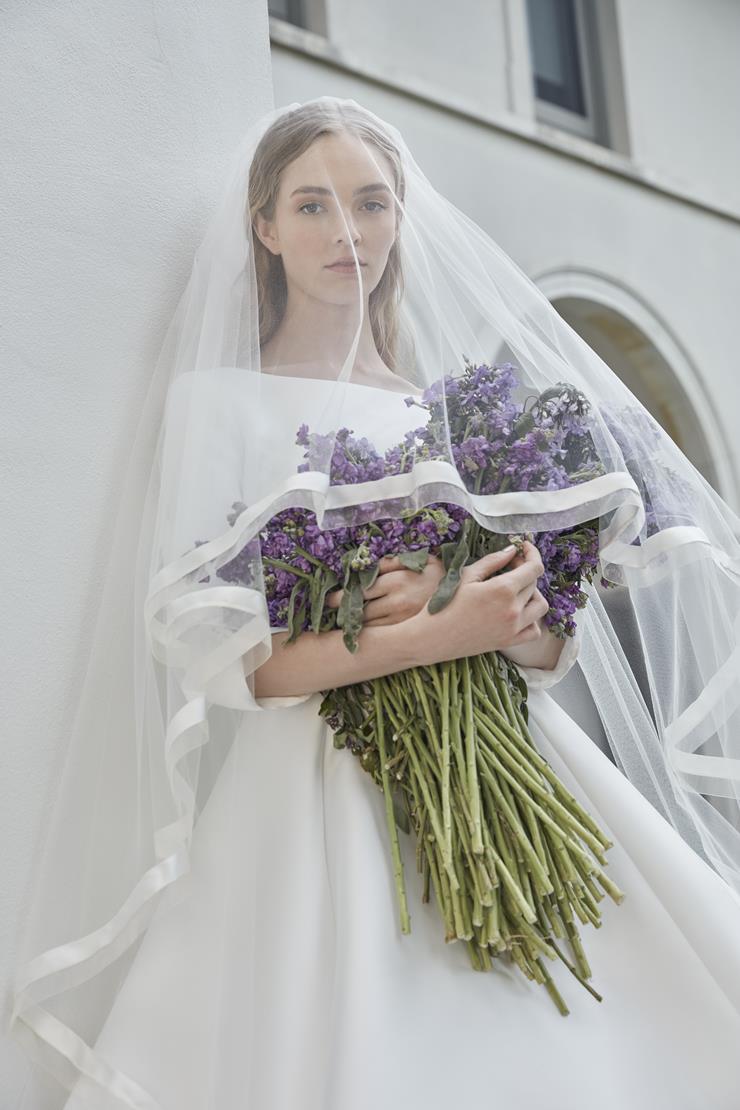 The Robe Magdalene is an elegant, a-line bridal gown fit for a princess. Its timeless design and flowing silhouette exude sophistication and grace. With its stunning appearance, this gown is perfect for any bride looking to make a statement on her special day.