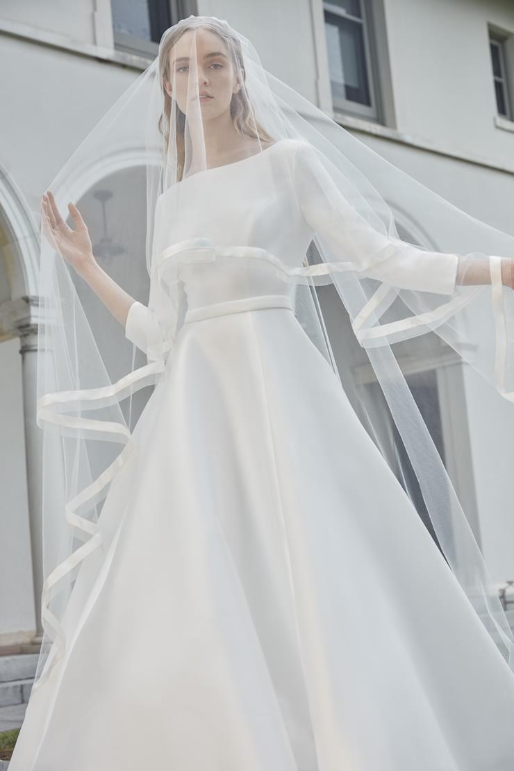 The Robe Magdalene is an elegant, a-line bridal gown fit for a princess. Its timeless design and flowing silhouette exude sophistication and grace. With its stunning appearance, this gown is perfect for any bride looking to make a statement on her special day.