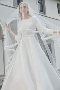 The Robe Magdalene is an elegant, a-line bridal gown fit for a princess. Its timeless design and flowing silhouette exude sophistication and grace. With its stunning appearance, this gown is perfect for any bride looking to make a statement on her special day.