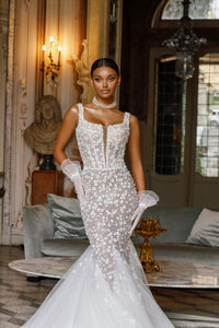 Elevate your bridal look with the Michelle Gown. The long mermaid train adds a touch of elegance to this stunning dress, making you feel like a true princess on your special day. With its perfect fit and classic design, this gown is sure to make you feel confident and beautiful.