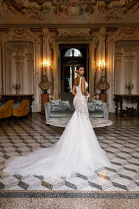 Elevate your bridal look with the Michelle Gown. The long mermaid train adds a touch of elegance to this stunning dress, making you feel like a true princess on your special day. With its perfect fit and classic design, this gown is sure to make you feel confident and beautiful.